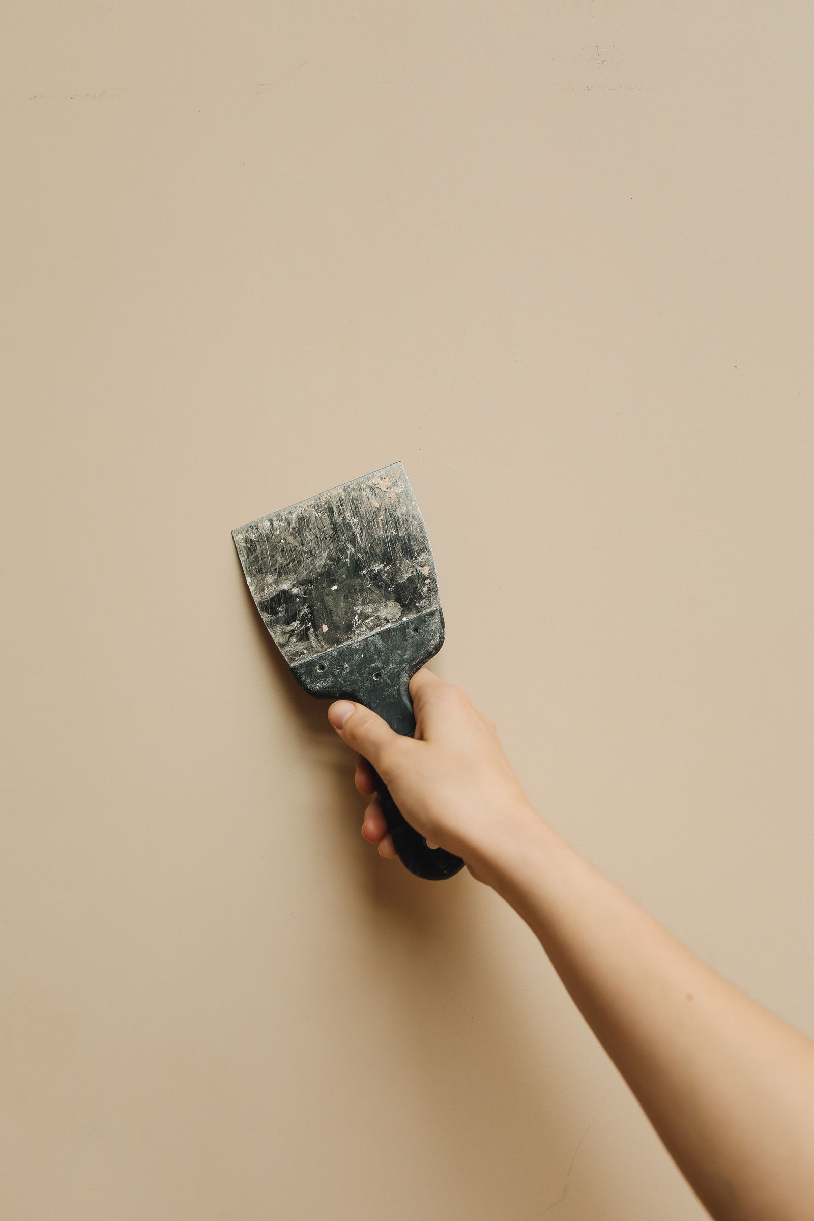 Steaming old wallpaper off a wall
